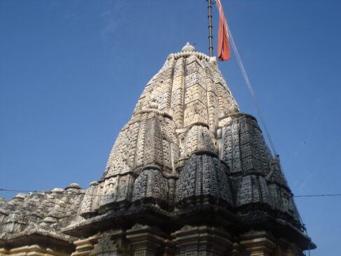 The Nagar style Shikhar is a hallmark of North Indian temple architecture, renowned for its grandeur and intricate design. This style is characterized by its towering, curvilinear spire (shikhar) that rises dramatically above the sanctum sanctorum (garbhagriha), symbolizing the connection between the earthly and the divine. The Nagar Shikhar typically features intricate carvings, delicate ornamentation, and harmonious symmetry, reflecting the artistic brilliance and spiritual ethos of ancient India. In Nagar-style temples, the Shikhar is often adorned with motifs of deities, floral patterns, and mythological narratives, representing a blend of art and spirituality. These temples are designed according to Vastushastra and Shilpshastra, ensuring both aesthetic beauty and cosmic alignment. The pinnacle of the Shikhar, called the kalash, signifies prosperity and divinity, crowning the temple with an auspicious presence. Prominent examples of Nagar-style Shikhar include the temples of Khajuraho, Gujarat's Sun Temple at Modhera, and Rajasthan's Dilwara Temples. These structures stand as timeless testaments to the architectural innovation and cultural richness of India’s temple-building traditions. At Devalaya Art, we embrace the principles of this revered style, recreating its splendor in modern temple designs and structures.